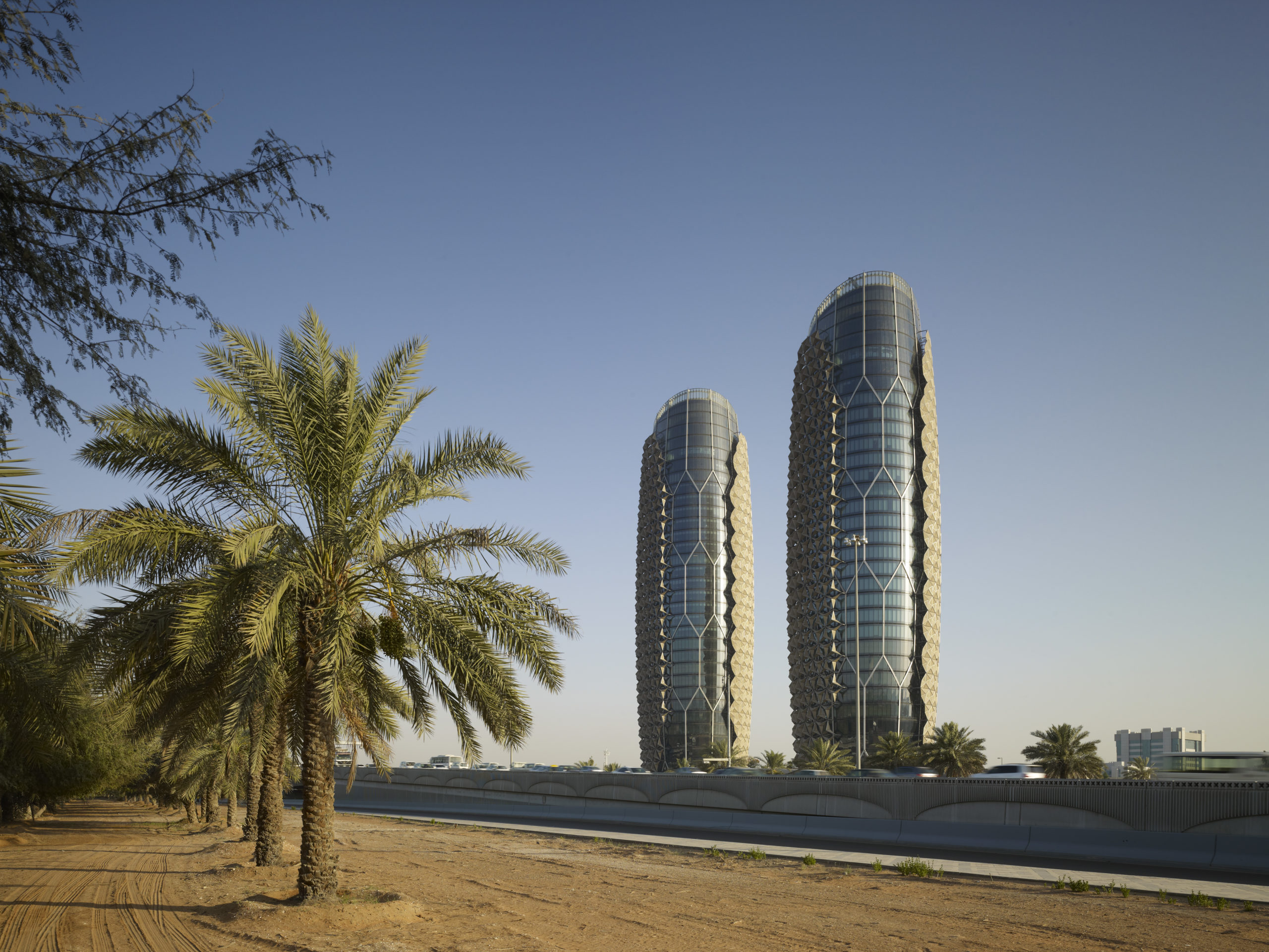 Figure 2. In Abu Dhabi, a set of towers by the design firm Aedas features a “breathing” exterior with an alluring effect: faceted fiberglass rosettes open and close depending on the façade’s temperature. Peter Oborn, Aedas director says, "It… responds to the aspiration of the emirate to take a leadership role in the area of sustainability". Photo Copyright: AHR / Christian Richter